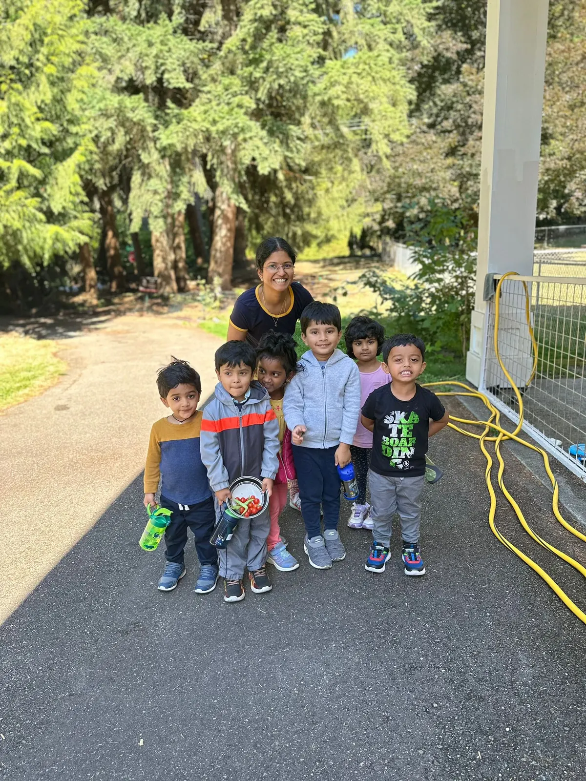 Children lined up with their teacher outside, ready for a walk