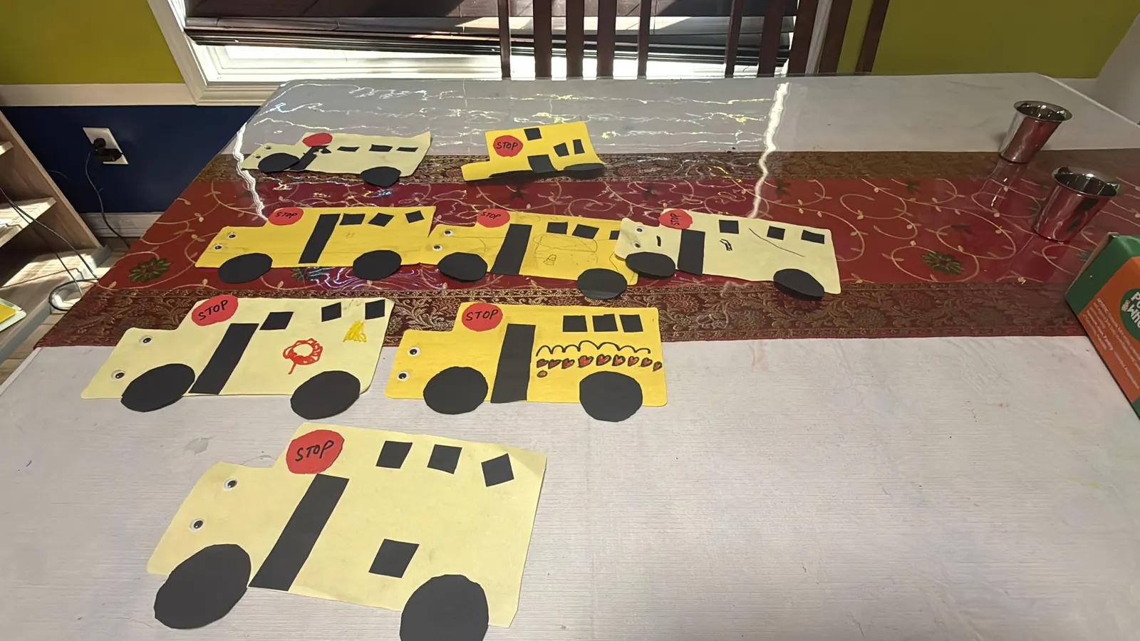 A row of paper school-bus crafts made by the children
