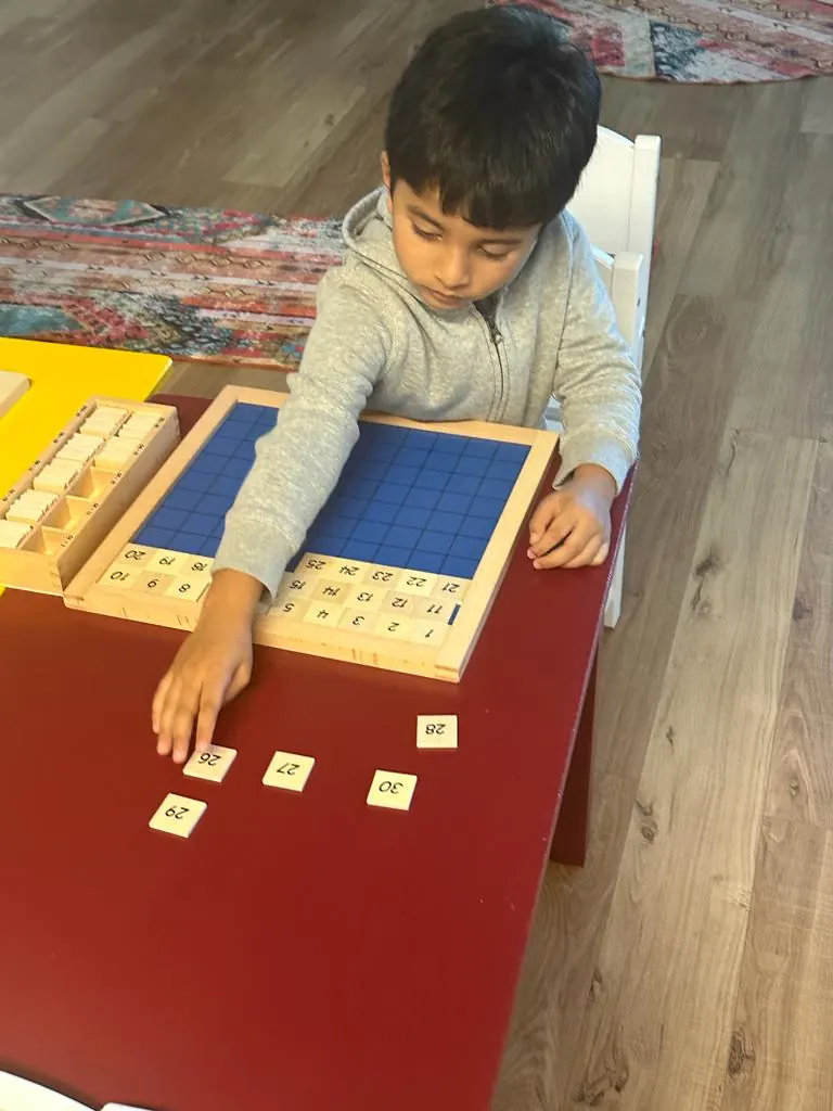 A child working on the hundred board