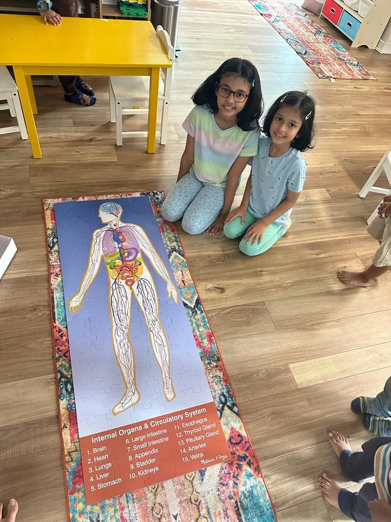 Two children with a human body chart