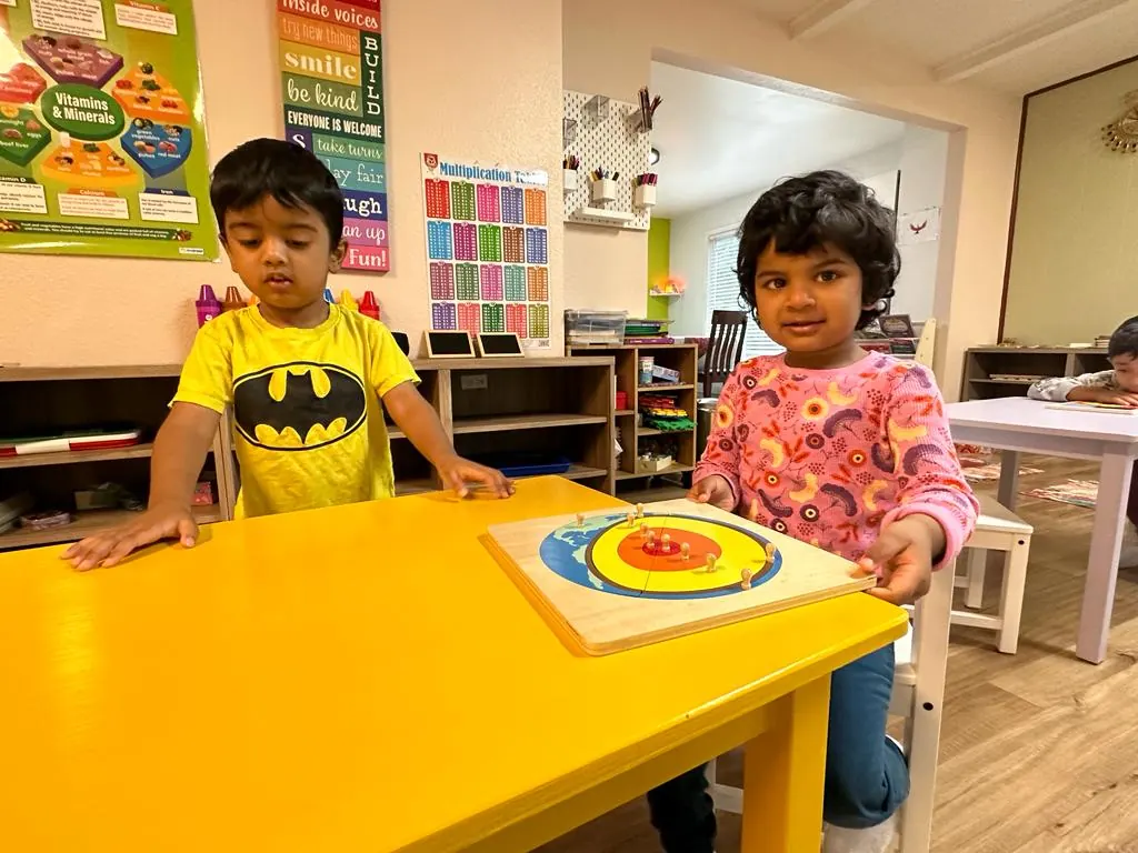 Two children working on a science puzzle together