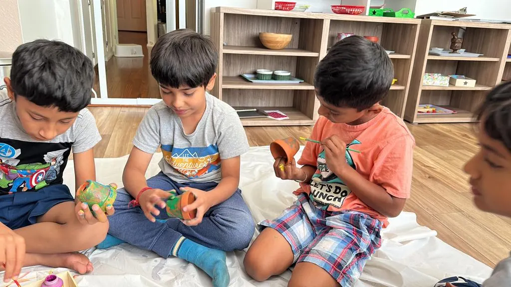 Children painting flower pots