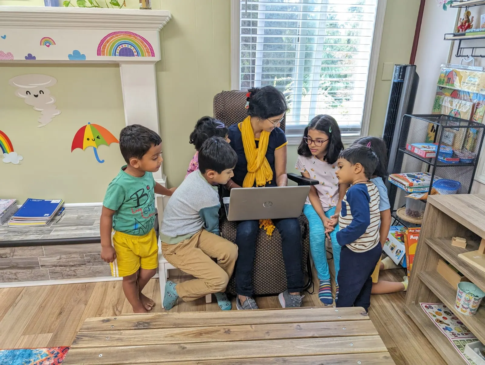 A group of children gathered around a coding lesson