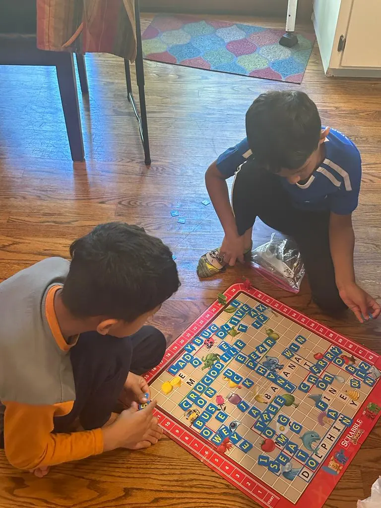 Children playing a board game on the floor