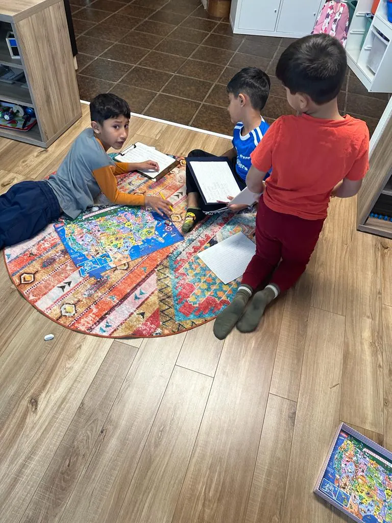 Children playing games on the classroom rug