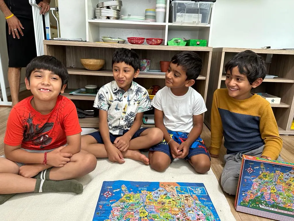 Four children proud of their finished 200-piece puzzle